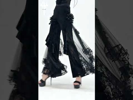 Gothic palazzo pants side walking view and close-up detail of ruffled mesh side panels on model