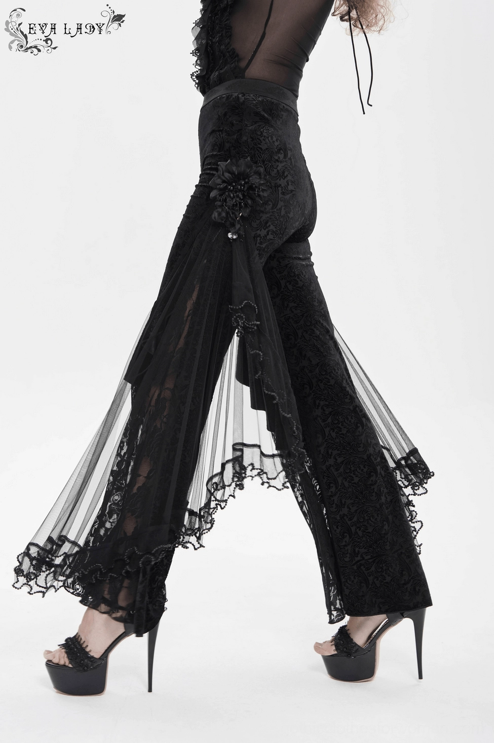 Gothic palazzo pants three-quarter length view with ornate side accents and layered mesh elements