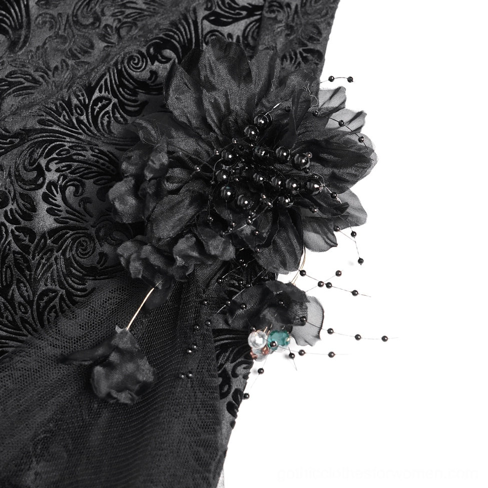 Close-up macro view of 3D beaded fabric flower embellishment and sheer mesh base on gothic pants