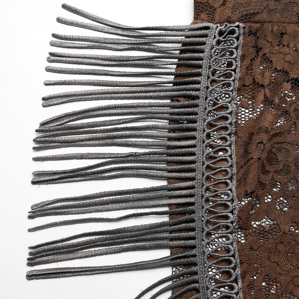 Close-up detail of decorative braided grey-black fringe trim and tassel embellishment on brown lace gothic pants