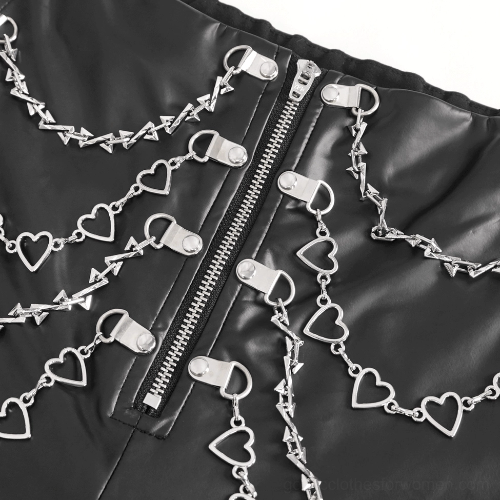 Close-up detail of heart metal chains and front zipper on gothic faux leather pants