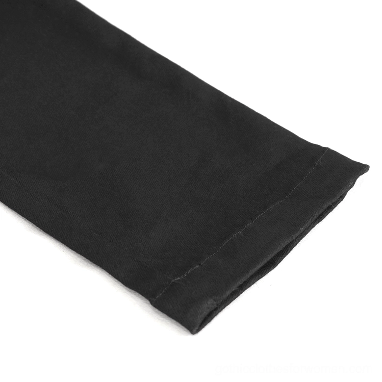 Close-up of stitched hem detail on black gothic slim-fit pants showing stretch fabric construction