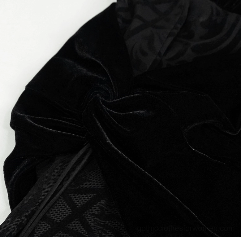 Hip detail close-up of black gothic flare pants highlighting draped velvet construction and subtle mesh lining