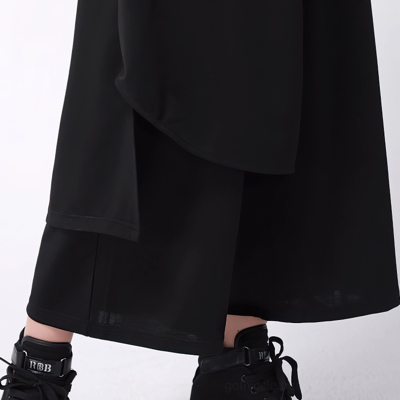 Close-up detail of gothic pants layered hem and matte woven fabric texture with platform sneakers