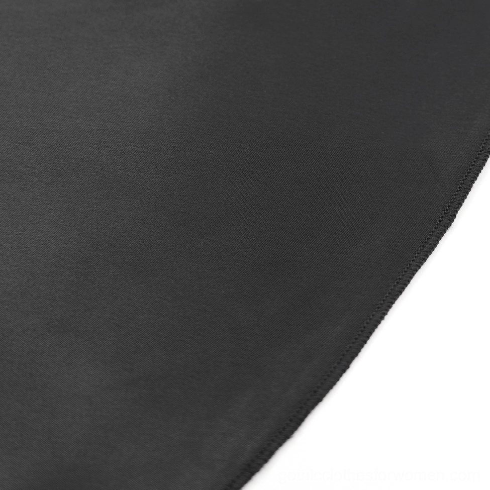 Gothic pants leg detail showcasing sheer lace overlay against satin fabric creating dramatic visual contrast