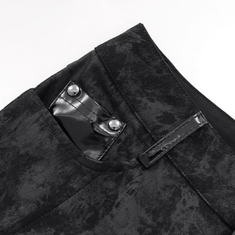 Close-up detail of black gothic pants side pocket showing patent leather flap and metal snap fastener