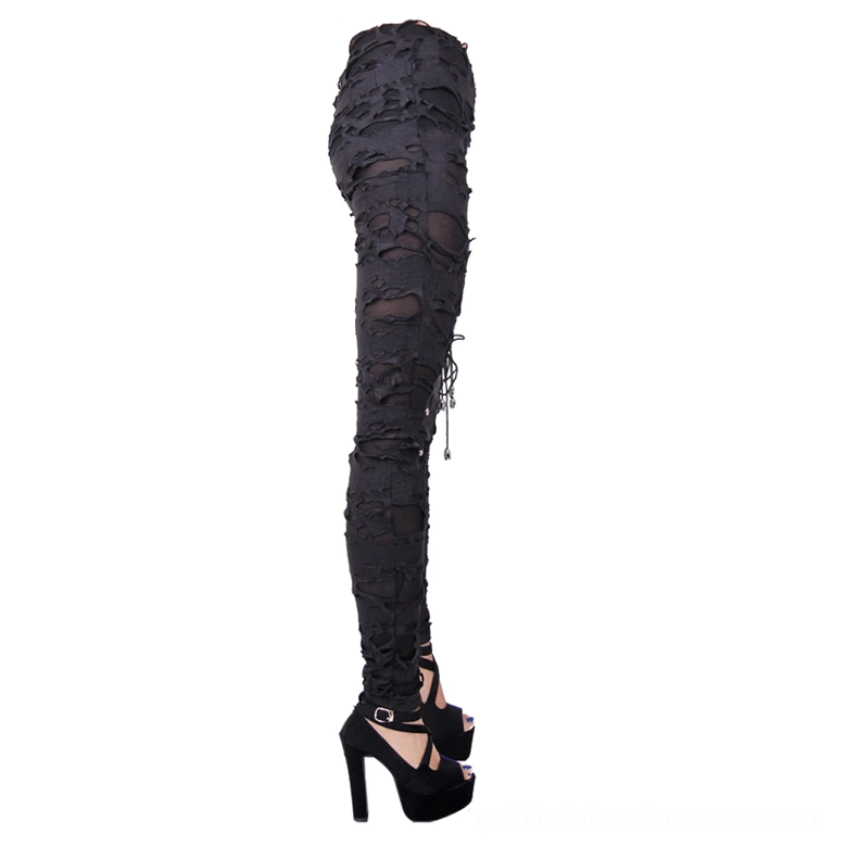 Side rear view of gothic high-waisted pants showing back lace-up detail and sheer mesh underlayer with platform heels