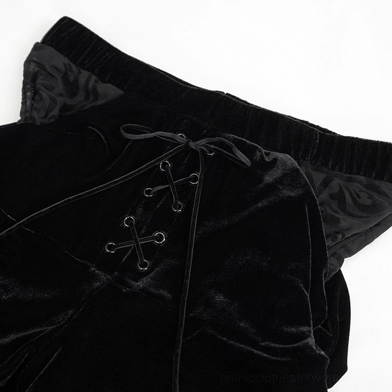 Close-up detail of gothic pants waistband showing cross lace-up fasteners, soft velvet fabric, and mesh side panels
