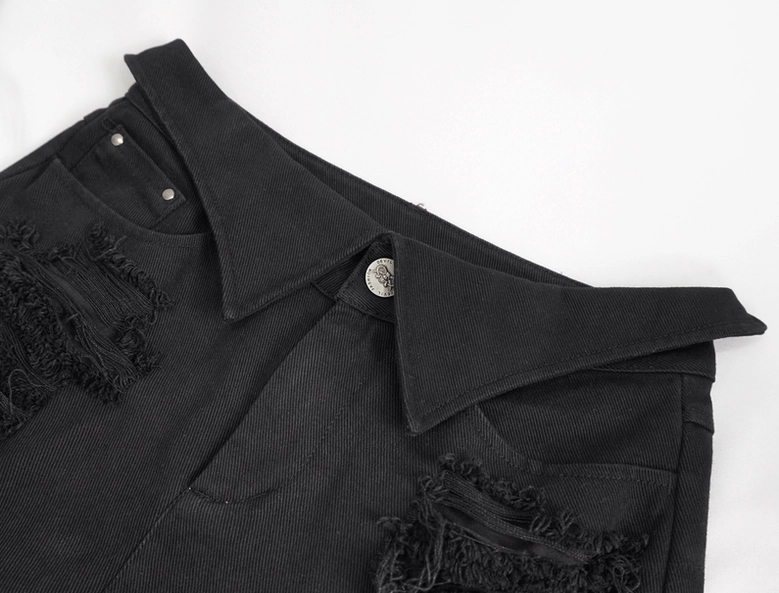 Close-up of black gothic pants waistband - showing metal button closure and distressed denim texture