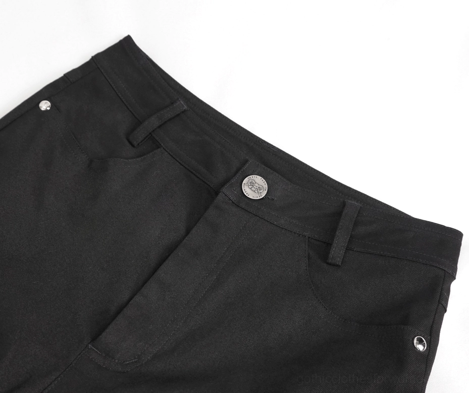 Close-up detail of waistband, metal button, belt loops and front pockets on black gothic slim-fit pants