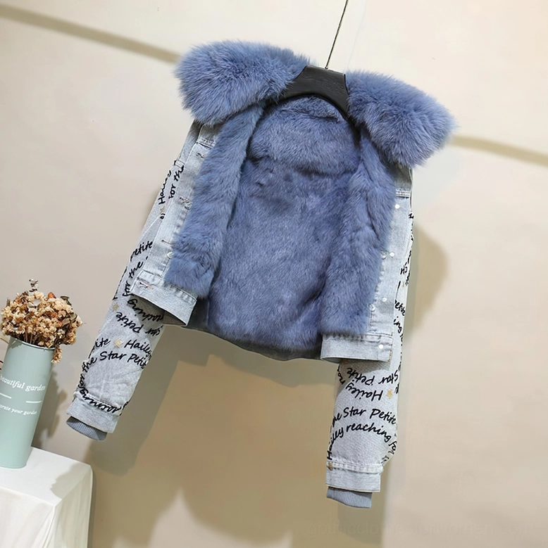 Hanging view of gothic denim parka with light blue fur collar and matching inner lining showing pearl details