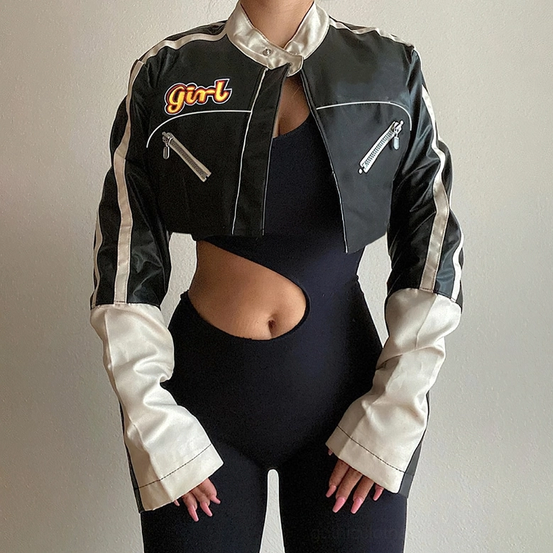 Close-up detail view of patchwork black and white gothic biker jacket showing color blocking construction and seams