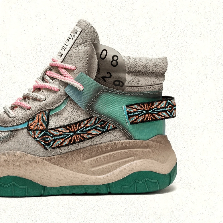 Detailed view of gothic platform boot construction showing patchwork leather panels, ethnic embroidery accents, and lace-up system