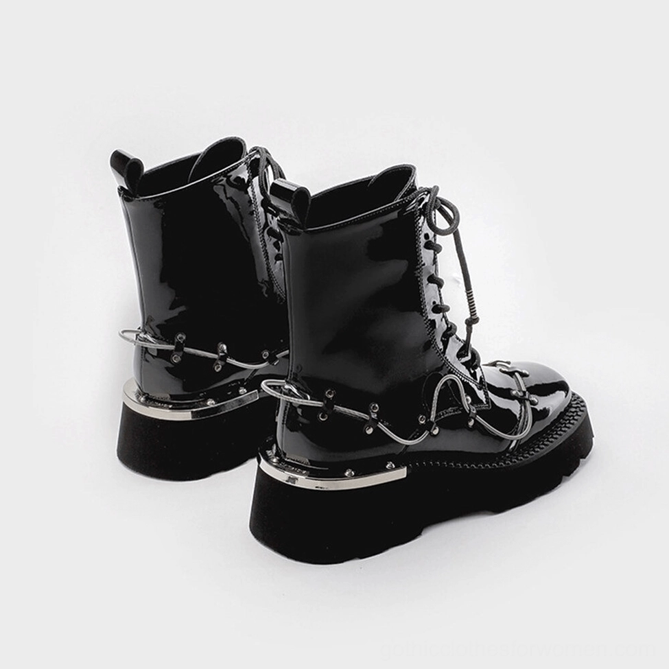 Black patent leather gothic ankle boots from back view, showing metal chain details and pull tab collar at ankle