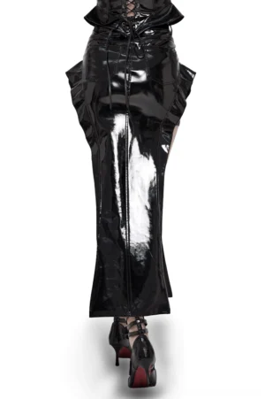 Back view of black glossy patent leather gothic maxi skirt with lace-up waist design and fishtail hem on model wearing red platform heels