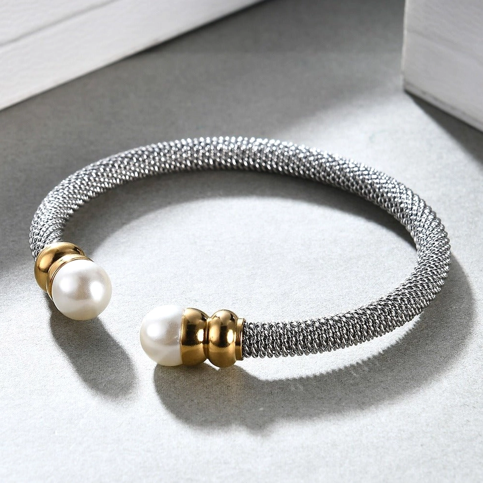 Light silver woven pearl bracelet displayed on white presentation box, product packaging view