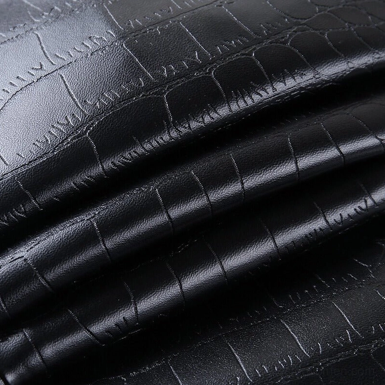 Black high-waist gothic faux leather pencil pants leg detail, showing tight ankle fit and smooth shiny faux leather finish