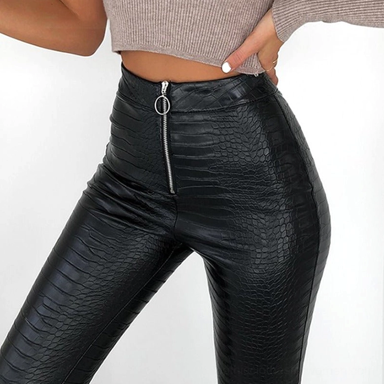 Side close-up detail of black gothic high-waist faux leather pants on model, showing front O-ring zipper and premium crocodile grain finish