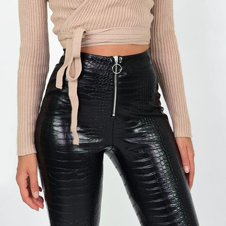 Fitted black high-waist gothic faux leather pencil pants on model, highlighting the skinny leg design and ankle-length cut