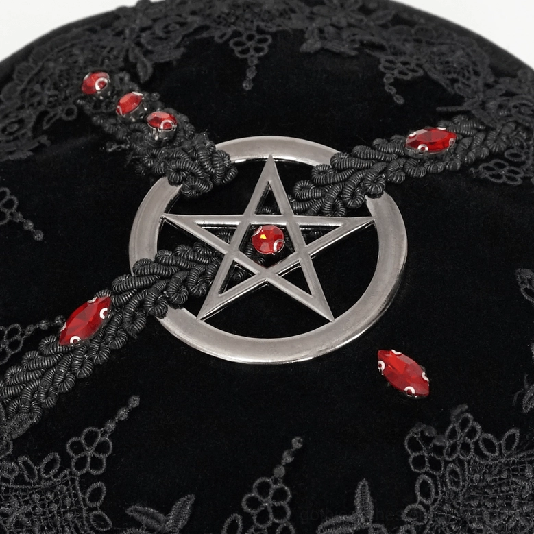 Extreme close-up of gothic bag front decoration featuring silver pentagram charm, red gemstones, braided trim, and floral lace base