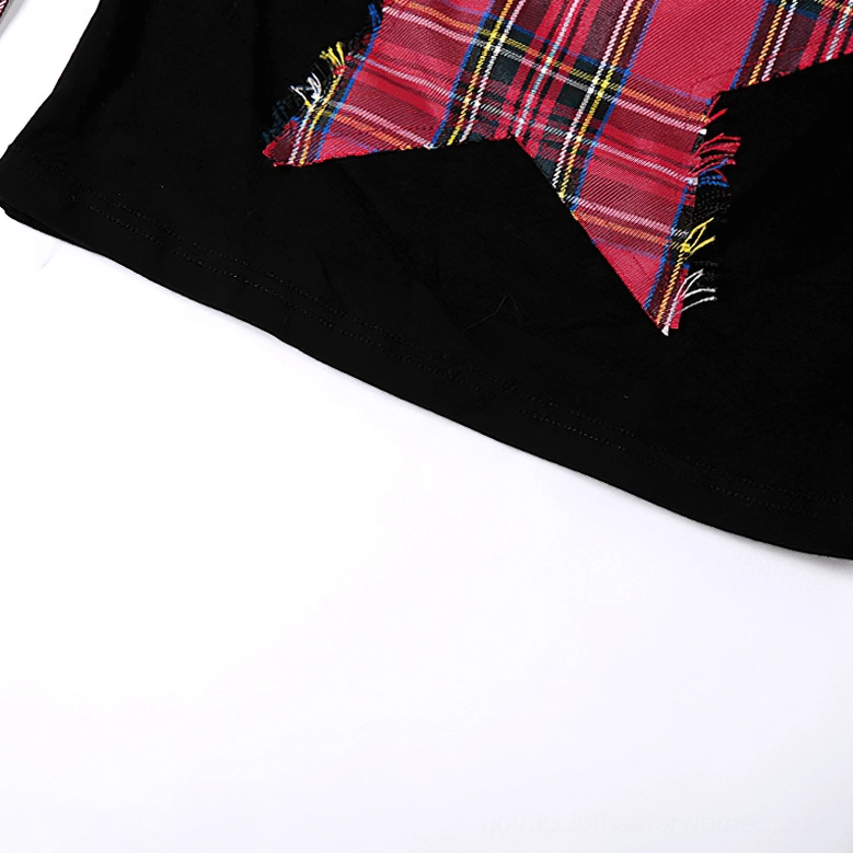 Macro close-up of pentagram patch with frayed raw edges and red tartan plaid framing on gothic crop top