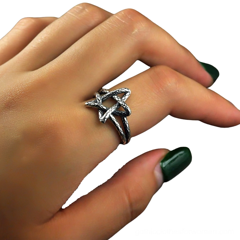 Adjustable pentagram ring worn on female hand with dark nail polish, gothic style accessory on index finger