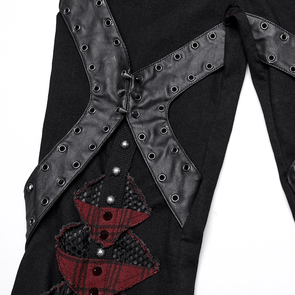 Gothic pants leg detail close-up showing x-shaped straps with metal studs and plaid inserts
