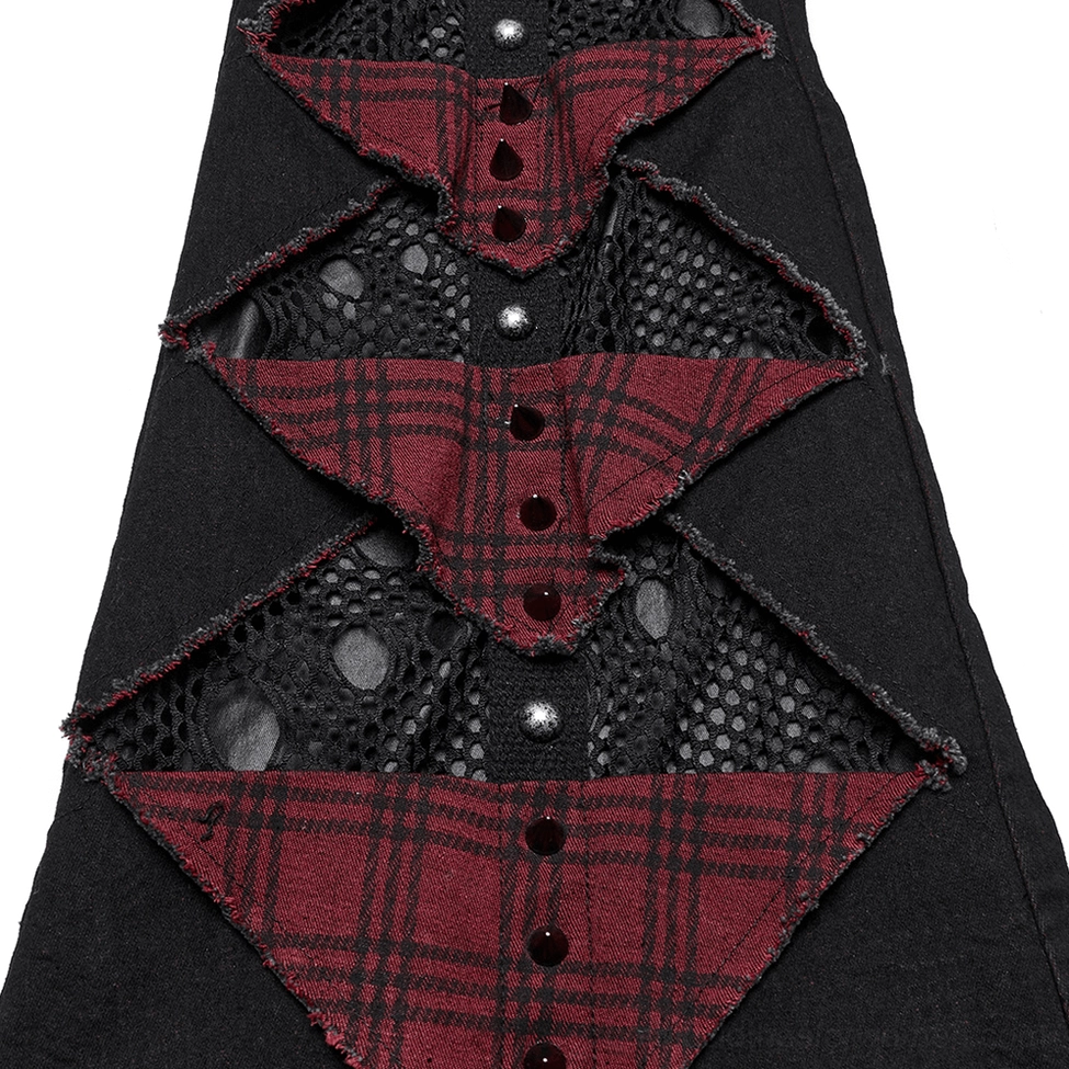 Gothic pants leg close-up showing red plaid patches fishnet mesh and stud decor