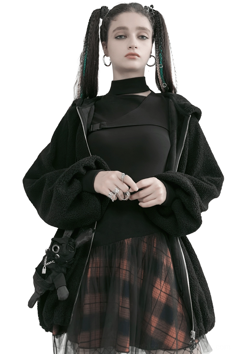 Front full-body view of black and orange plaid gothic mesh mini skirt styled with black turtleneck and fuzzy cardigan on fashion model with twin braids