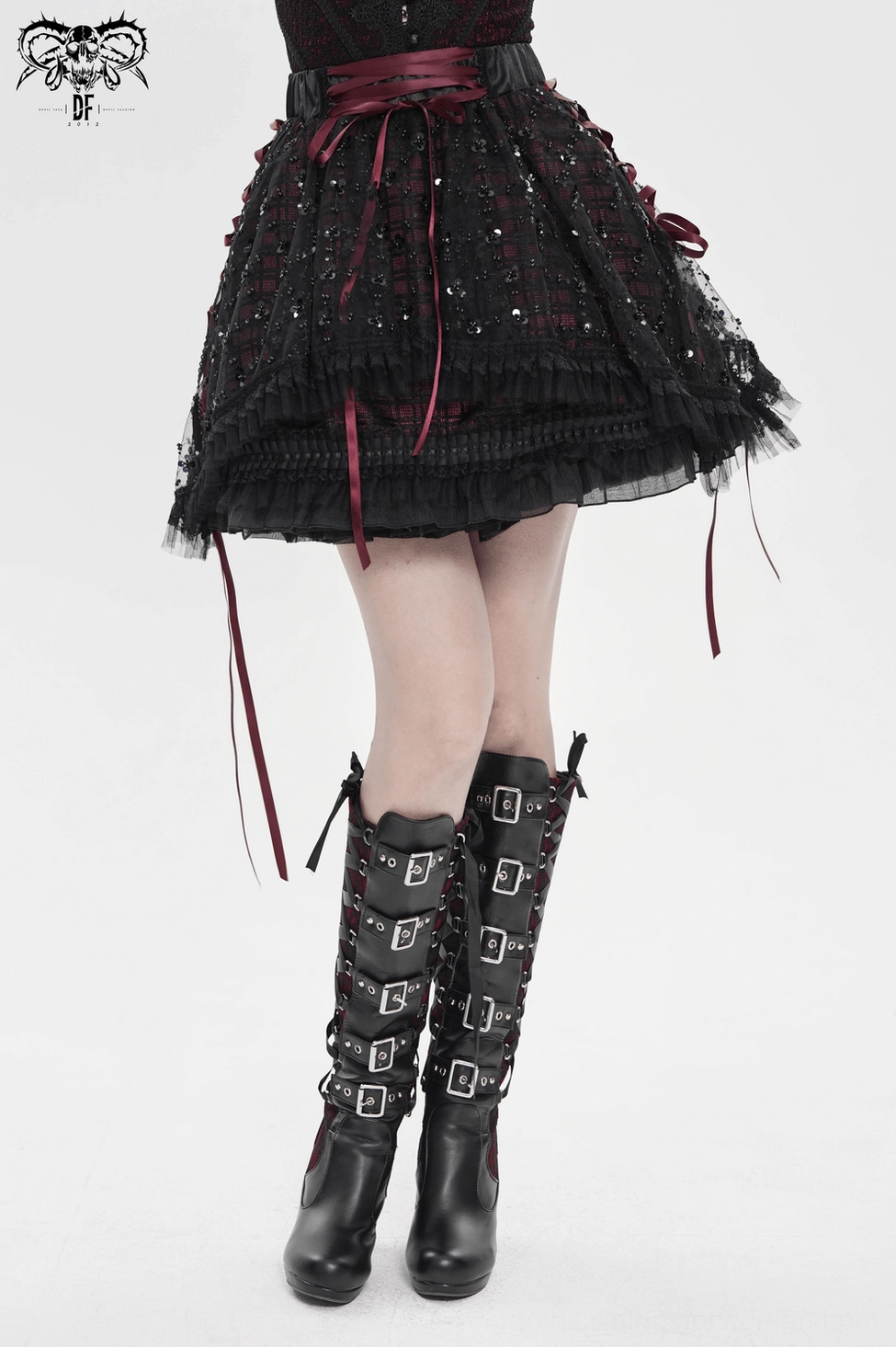 Gothic plaid tulle skirt with corset-inspired ribbon lacing showing waist definition and romantic goth aesthetic