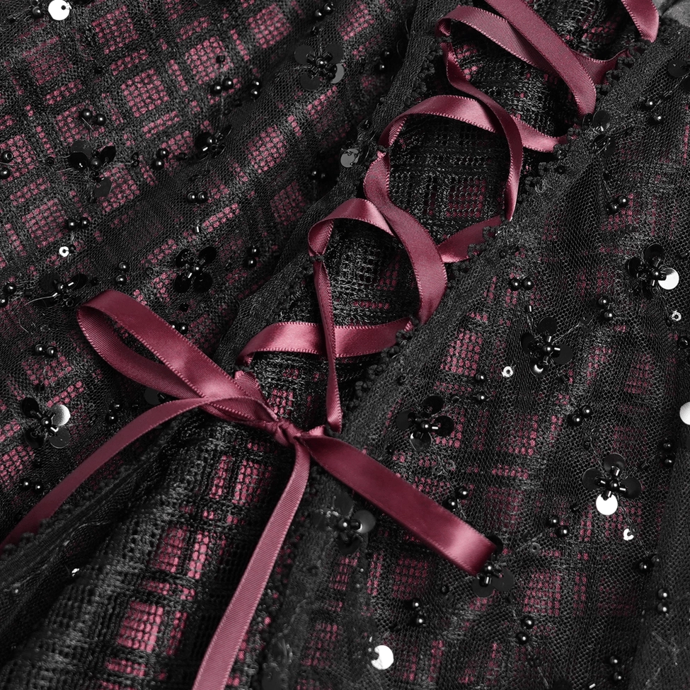 Gothic plaid tulle skirt detail shot displaying layered tulle ruffles and romantic texture construction