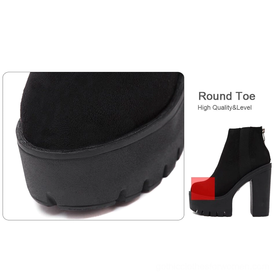 Black gothic platform ankle boots three-quarter angle view emphasizing square heel geometry and dark suede aesthetic