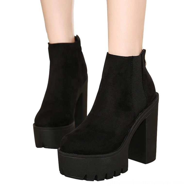 Black gothic platform ankle boots with back zipper and side elastic panels, front view on model showing architectural heel structure