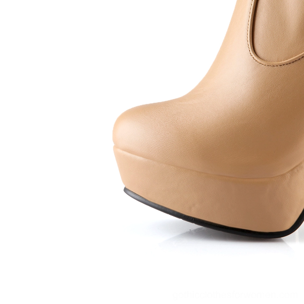 Close-up of tan gothic over-the-knee platform boot heel, chunky square block heel and smooth leather texture