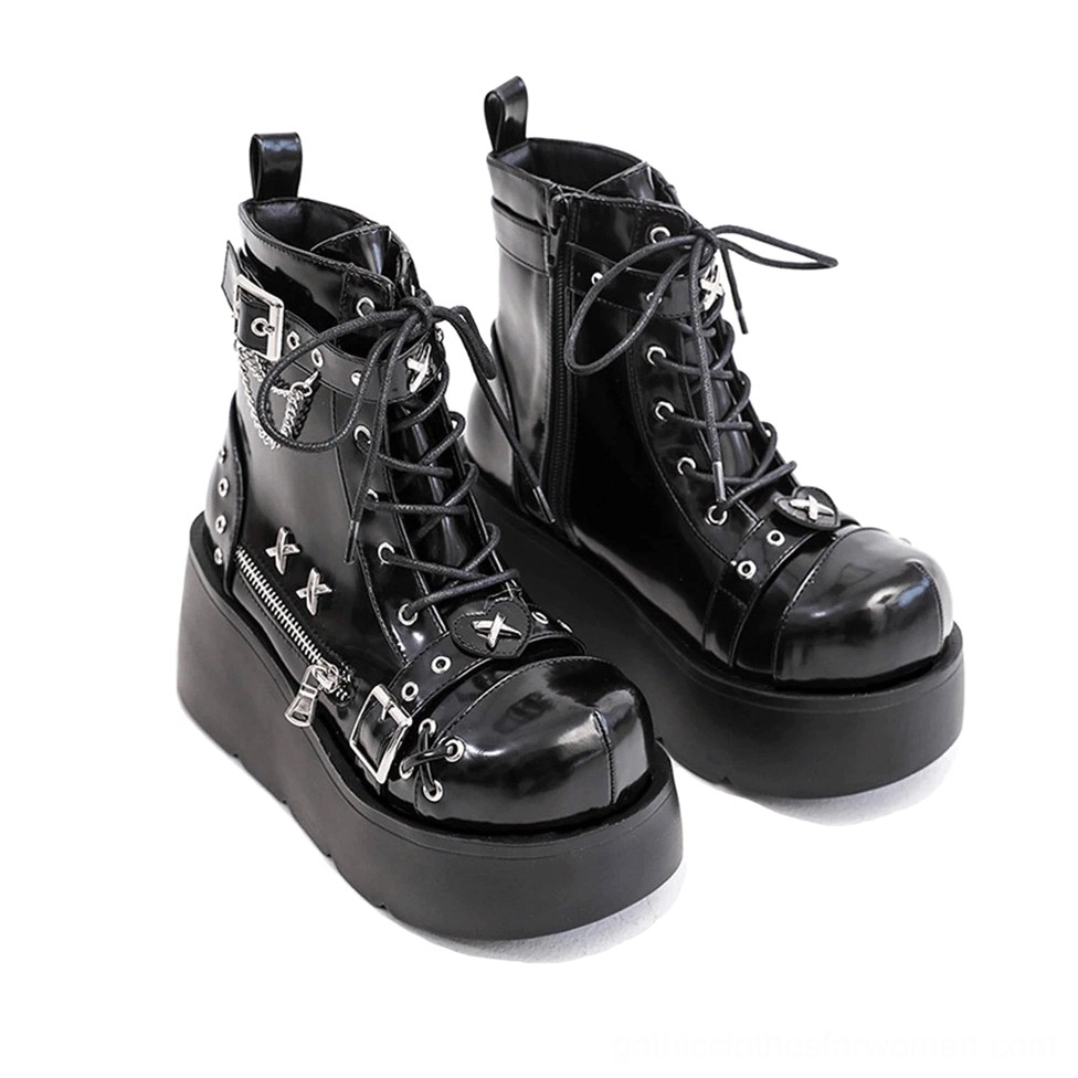 Black patent leather platform ankle boots with chain buckle details - side view showing wedge heel and lace-up front