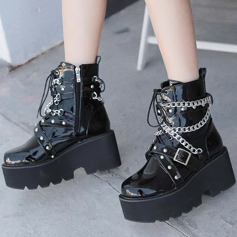 Gothic platform boots detailed lifestyle shot showing chain hardware, patent leather shine, and alternative fashion styling