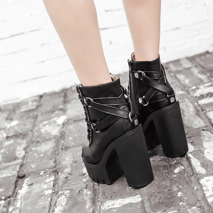 Model wearing black gothic platform ankle boots rear side view outdoor - multiple buckle straps and high block heel on street setting