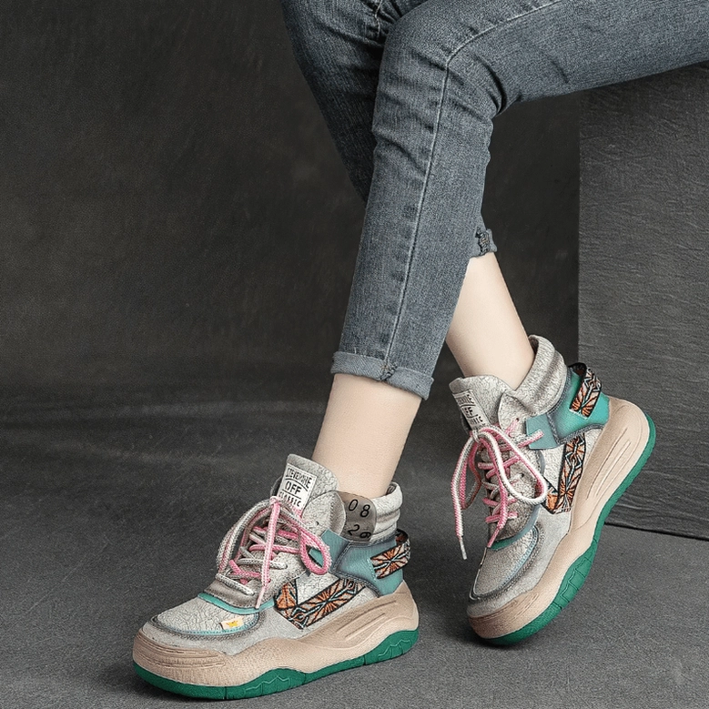 Woman wearing black gothic platform patchwork boots with skinny jeans, side close-up of feet and boot silhouette