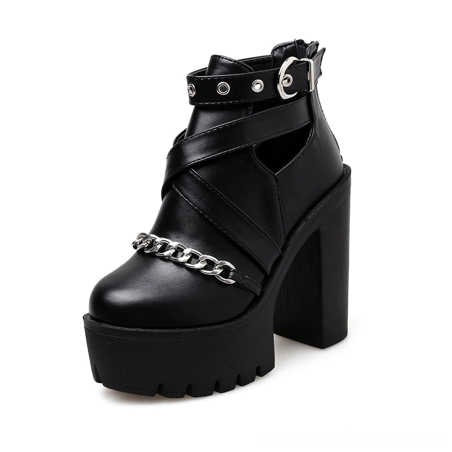 Gothic platform ankle boots side three-quarter angle showing thick block heel structure and cutout ankle strap design