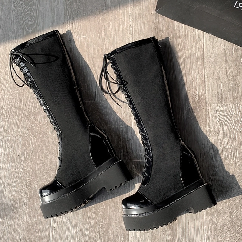 Black gothic platform boots detailed view of premium flock and patent leather materials showing texture contrast and gothic aesthetic