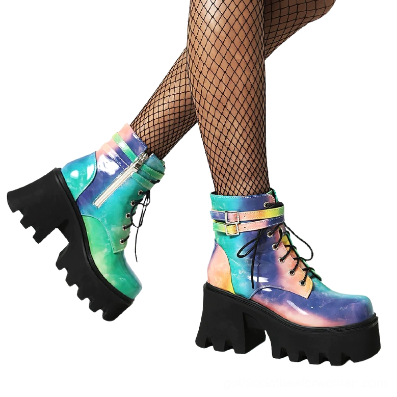 Woman wearing tie-dye gothic platform ankle boots with fishnet stockings, low side angle view showcasing chunky lug sole and zipper