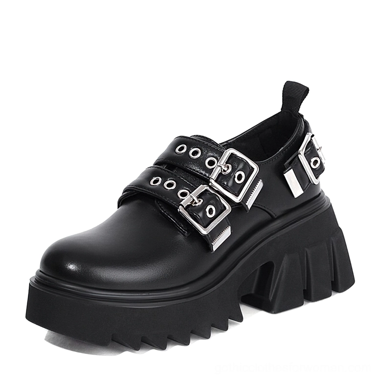 Black matte PU leather gothic platform loafers with dual silver metal buckles, three-quarter left view showing round toe and serrated chunky platform sole