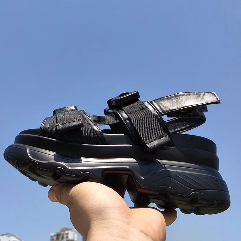 Black platform sandal outsole with heavy-duty lug pattern for alternative fashion wear
