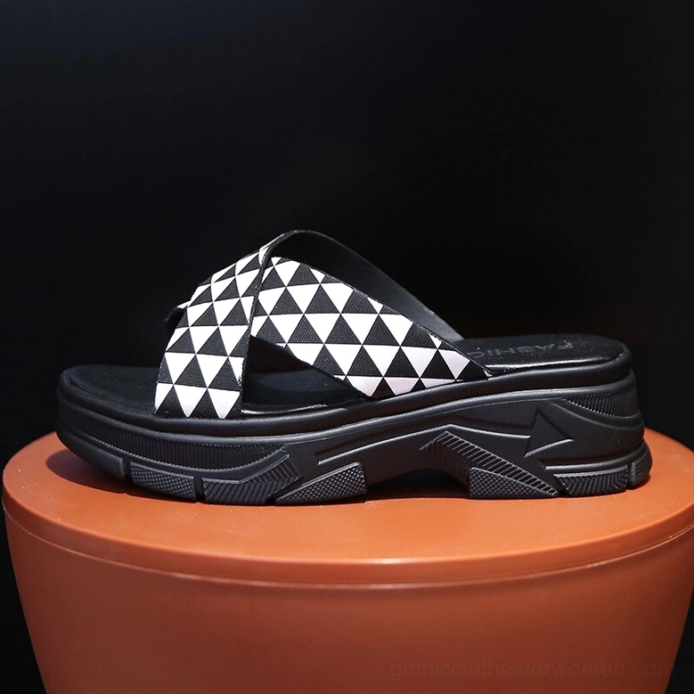 Single gothic platform crisscross sandal with black and white geometric straps and thick chunky sole, side profile view