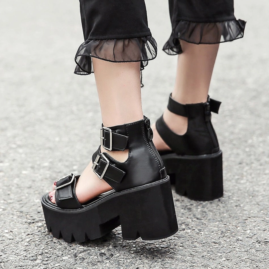 Black gothic platform sandals detailed product photography showing buckle strap system, matte finish, and architectural platform heel construction
