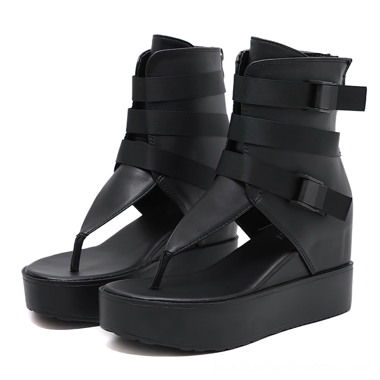 Black gothic platform sandals with multiple buckle straps and rear zipper, front paired view showing thong toe design and industrial hardware details