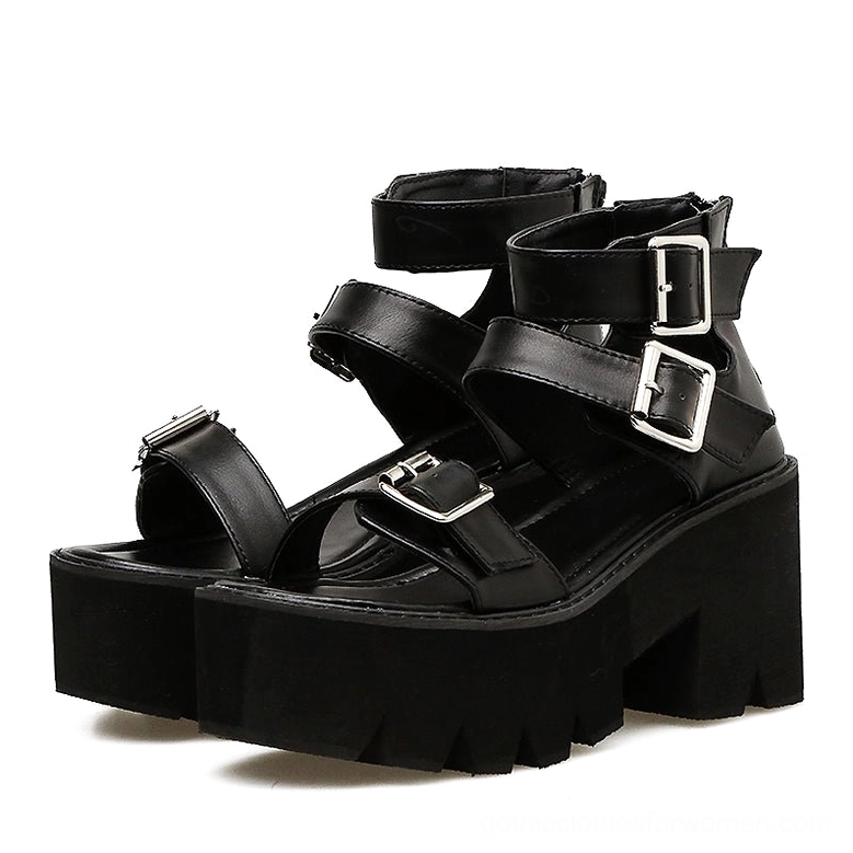 Black gothic platform sandals with multi-buckle ankle straps, front three-quarter view showing open toe design and structural heel