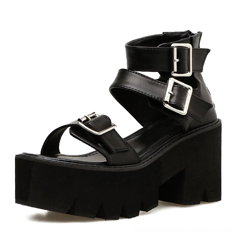 Black gothic platform sandals side three-quarter view displaying ankle strap buckles and imposing block heel structure