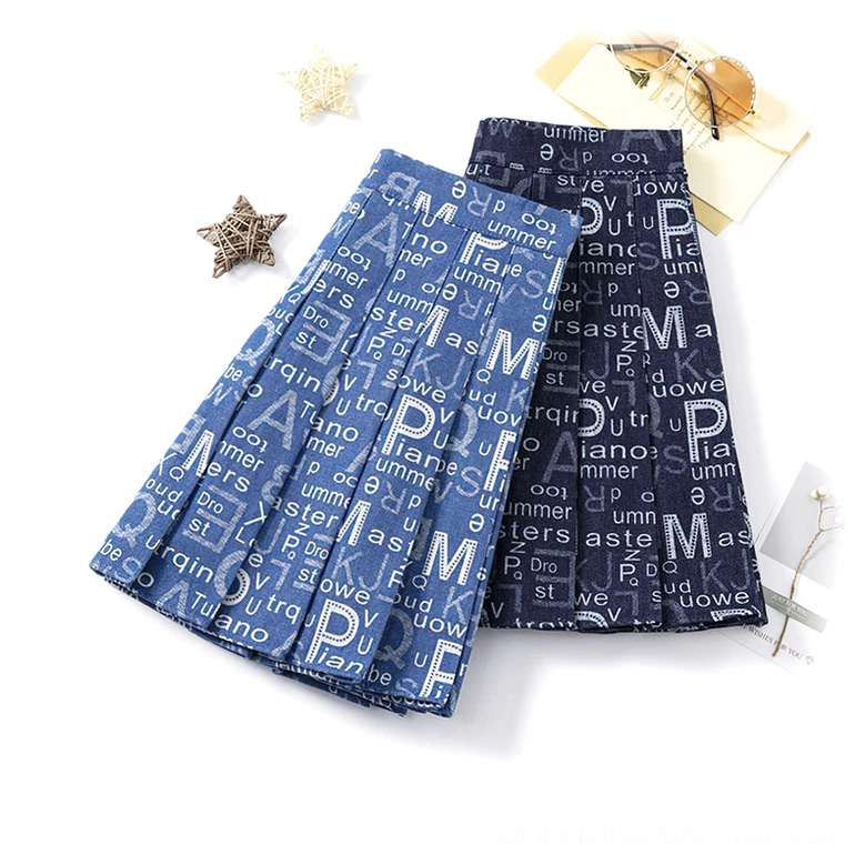 Two pleated typographic denim mini skirts oblique flat lay view, letter print pattern detail, alternative fashion