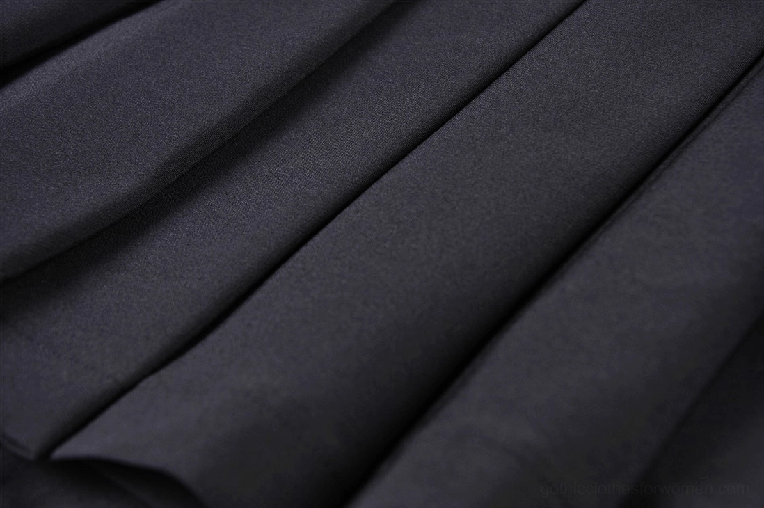 Black gothic mini skirt fabric texture and pleated construction detail close-up